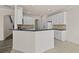 Modern kitchen with white cabinets, backsplash, and breakfast bar at 6468 Panasa Ct, Tucker, GA 30084