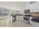 Well-lit kitchen features stainless appliances, granite counters, and tile floors at 6468 Panasa Ct, Tucker, GA 30084