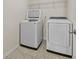 Bright laundry area with front-loading washer and dryer and shelf at 6468 Panasa Ct, Tucker, GA 30084
