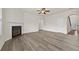 Large living room with fireplace, wood floors, and access to other rooms at 6468 Panasa Ct, Tucker, GA 30084