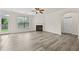 Open living room features sleek floors, a fireplace, and access to the backyard at 6468 Panasa Ct, Tucker, GA 30084
