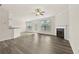 Spacious living room with sleek floors, a ceiling fan, and a cozy fireplace at 6468 Panasa Ct, Tucker, GA 30084