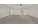 Carpeted main bedroom with fan and multiple doorways at 6468 Panasa Ct, Tucker, GA 30084