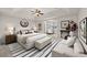 Serene primary bedroom with a king bed, sitting area, and lots of natural light at 6468 Panasa Ct, Tucker, GA 30084