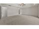 Large carpeted main bedroom with ceiling fan and multiple doorways at 6468 Panasa Ct, Tucker, GA 30084