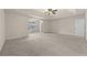 Large main bedroom with carpet, tray ceiling, and ceiling fan at 6468 Panasa Ct, Tucker, GA 30084