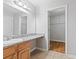 Bright bathroom featuring a granite countertop and adjacent closet with storage at 106 Brighton Pt, Sandy Springs, GA 30328