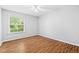 Clean bedroom features neutral paint, hardwood floors, a ceiling fan, and natural light at 106 Brighton Pt, Sandy Springs, GA 30328