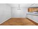 Open dining area with wood floors, modern lighting and view of kitchen at 106 Brighton Pt, Sandy Springs, GA 30328