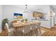 Inviting dining area with sleek wood table, six chairs, modern lighting and wood floors at 106 Brighton Pt, Sandy Springs, GA 30328