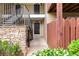Condo entrance with metal stairs and railings, stone accents, and wooden fence at 106 Brighton Pt, Sandy Springs, GA 30328