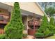 Two-story townhome with wood deck, manicured landscaping, and wood and stone exterior at 106 Brighton Pt, Sandy Springs, GA 30328