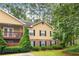 Charming two-story townhouse with a balcony, and stone accents, nestled in a lush, green landscape at 106 Brighton Pt, Sandy Springs, GA 30328