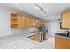 Well-lit kitchen with granite counters, wood cabinets, stainless steel appliances and ceramic tile flooring at 106 Brighton Pt, Sandy Springs, GA 30328