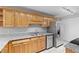 Well-lit kitchen with granite counters, wood cabinets, stainless steel appliances and ceramic tile flooring at 106 Brighton Pt, Sandy Springs, GA 30328