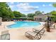 Community pool area with ample lounge seating, mature trees, and inviting recreational space at 106 Brighton Pt, Sandy Springs, GA 30328