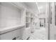 Spacious walk-in closet with custom shelving, drawers, and marble floors; includes washer and dryer at 1812 Hunters Gln, Marietta, GA 30062