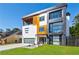 Stunning modern exterior with multi-tone facade, sleek lines, balcony, and attached garage at 1812 Hunters Gln, Marietta, GA 30062