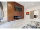 Stylish living room featuring a fireplace with a wood-paneled accent wall and sleek marble floors at 1812 Hunters Gln, Marietta, GA 30062