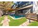 Backyard oasis featuring a sparkling pool, stone accents, and a relaxing shaded lounge area at 1812 Hunters Gln, Marietta, GA 30062