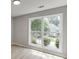 Bright bedroom featuring a large window with views of the well-maintained, green neighborhood at 2420 Walnut Grove Way, Suwanee, GA 30024