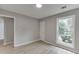 This bedroom features bright windows, light gray walls, and wood-look flooring at 2420 Walnut Grove Way, Suwanee, GA 30024