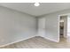 This bedroom features light gray walls, wood-look flooring, and a peek into the bathroom at 2420 Walnut Grove Way, Suwanee, GA 30024