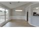 Charming dining room with backyard access and views, complemented by modern lighting at 2420 Walnut Grove Way, Suwanee, GA 30024