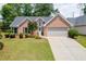 Traditional brick home with a two-car garage and well-manicured lawn at 2420 Walnut Grove Way, Suwanee, GA 30024