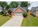Charming brick home with a two-car garage and landscaped front yard at 2420 Walnut Grove Way, Suwanee, GA 30024