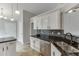 Kitchen features stainless steel appliances, black countertops, and white cabinets at 2420 Walnut Grove Way, Suwanee, GA 30024
