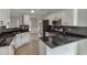 Kitchen showcasing black countertops and modern stainless steel appliances at 2420 Walnut Grove Way, Suwanee, GA 30024