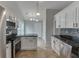 Modern kitchen with stainless steel appliances and black countertops at 2420 Walnut Grove Way, Suwanee, GA 30024