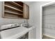 Laundry room area showcasing shelving and modern washer and dryer at 2420 Walnut Grove Way, Suwanee, GA 30024