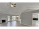 Open-concept living space with wood-look flooring, ceiling fan, and views into the kitchen at 2420 Walnut Grove Way, Suwanee, GA 30024