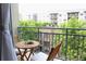 Cozy balcony with seating and views of the neighborhood and mature trees at 711 Cosmopolitan Dr # 413, Atlanta, GA 30324