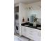 Bathroom featuring dual sinks, modern vanity, and stacked washer and dryer at 711 Cosmopolitan Dr # 413, Atlanta, GA 30324