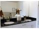 Modern bathroom featuring dual sinks with granite countertops and white cabinets at 711 Cosmopolitan Dr # 413, Atlanta, GA 30324