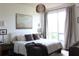Serene bedroom with a comfortable bed, stylish lighting, and natural light from a large window at 711 Cosmopolitan Dr # 413, Atlanta, GA 30324