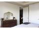 Bright bedroom featuring a dresser with decorative gold mirror and closet at 711 Cosmopolitan Dr # 413, Atlanta, GA 30324