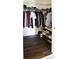 Walk-in closet with wood floors, wire shelving, and hanging clothes at 711 Cosmopolitan Dr # 413, Atlanta, GA 30324