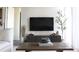 Modern living room features a wall-mounted TV, stylish console, and decorative plants at 711 Cosmopolitan Dr # 413, Atlanta, GA 30324