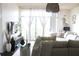 Inviting living room with comfortable seating, soft textures, and natural light streaming through large windows at 711 Cosmopolitan Dr # 413, Atlanta, GA 30324