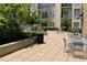 Charming patio area with tables, chairs, and well-maintained landscaping, perfect for outdoor relaxation at 711 Cosmopolitan Dr # 413, Atlanta, GA 30324
