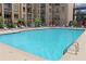 Refreshing outdoor pool with lounge chairs and views of the surrounding residential building at 711 Cosmopolitan Dr # 413, Atlanta, GA 30324