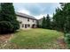 Expansive backyard featuring a lush lawn and mature trees, creating a private outdoor space at 1336 Nathan Mauldin Dr, Lawrenceville, GA 30043