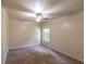 Bedroom with neutral carpet, a ceiling fan, and a window that brings in natural light at 1336 Nathan Mauldin Dr, Lawrenceville, GA 30043