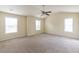 Spacious bedroom with three windows, neutral paint, and plush carpeting at 1336 Nathan Mauldin Dr, Lawrenceville, GA 30043