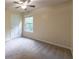 Bedroom featuring neutral carpet, a window, and a ceiling fan at 1336 Nathan Mauldin Dr, Lawrenceville, GA 30043