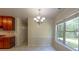 Bright breakfast nook featuring a chandelier, large window with backyard view, and tile floors at 1336 Nathan Mauldin Dr, Lawrenceville, GA 30043